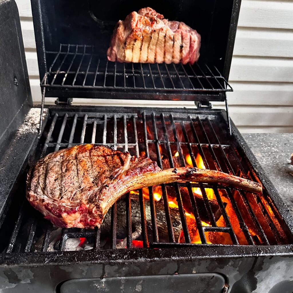 Perfectly grilled tomahawk steak from pasture raised Black Market Cattle Beef. sourced and prepared farm to table on the Shaner-Yamana Farm in Tallassee, Alabama