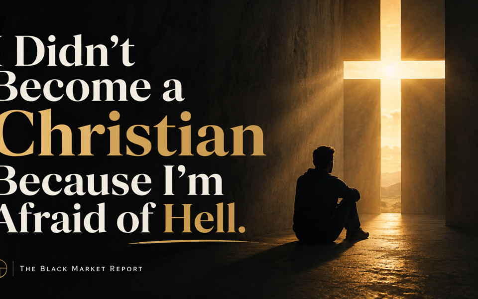 Cinematic graphic reading “I Didn’t Become a Christian Because I’m Afraid of Hell” beside a man sitting alone on the floor of a dark stone room, looking toward a cross-shaped opening that floods the space with golden light. The Black Market Report.